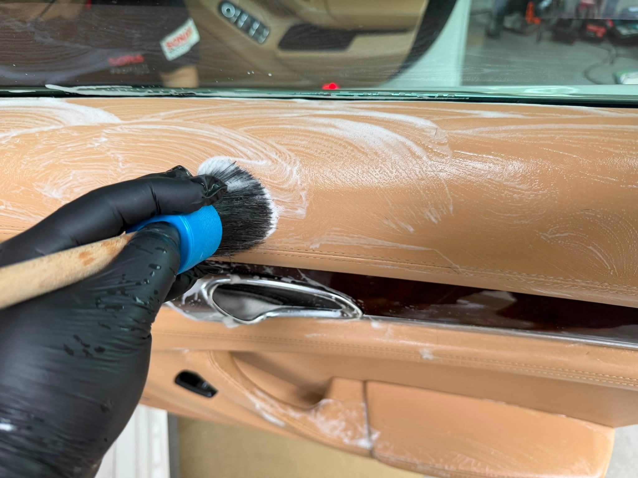 Professional interior leather shampoo scrub on Porsche Panamera cognac leather door panel Singapore